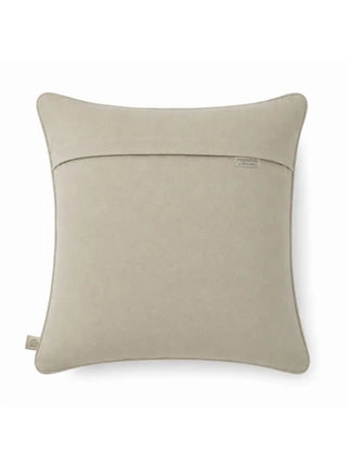 The reverse side view of the Zayan Weave cushion cover showing the clean mineral gray suede backing, hidden zipper closure, and brand woven tag.